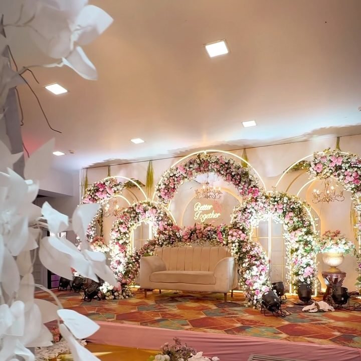 Floral reception stage in the banquet hall at Meera Celebration